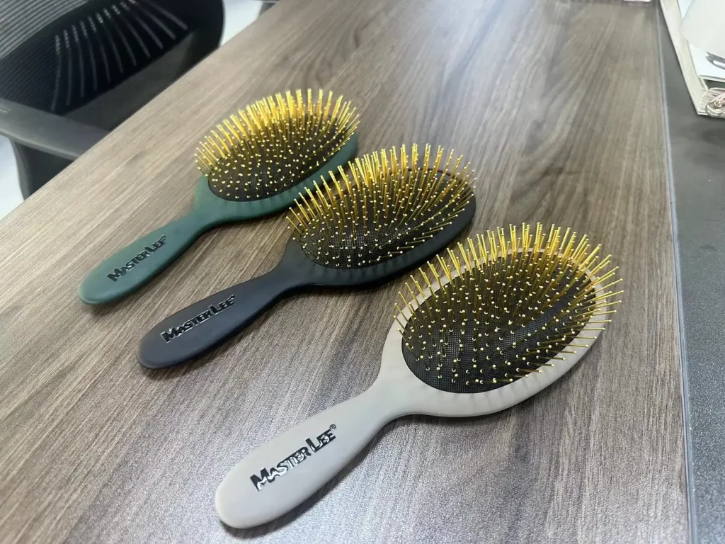 Hair brushes with printed handles beside hair extensions
