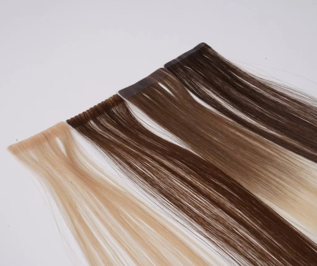 Tape-in hair pieces with blonde and rooted brown shades