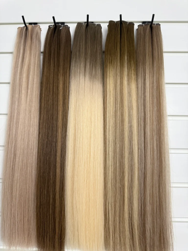 Weft hair in brown and blonde shades on a display rail